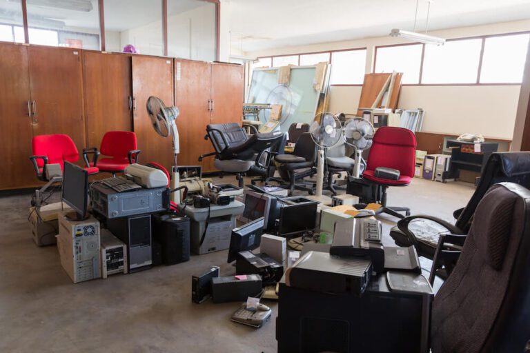 Office items stacked into centre of room ready for office clearance